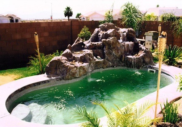 dark-fence-waterfall-swimming-pool-with-rock