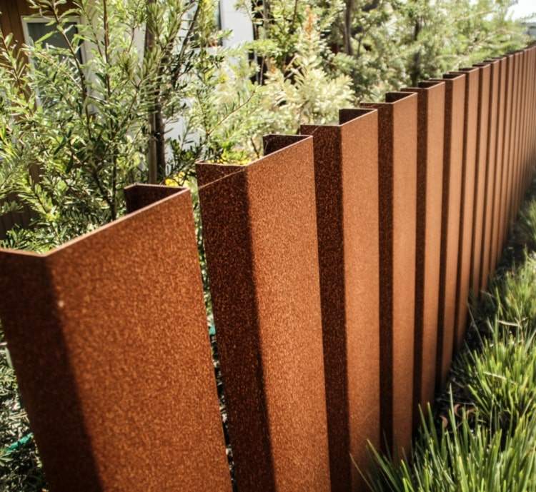 Vigas de aço enferrujado como uma tela de privacidade de aço corten e cerca no jardim