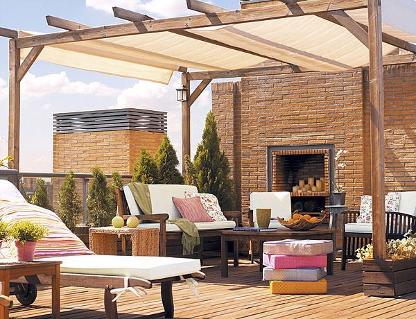terraço pergola tecido proteção solar lareira parede de tijolos
