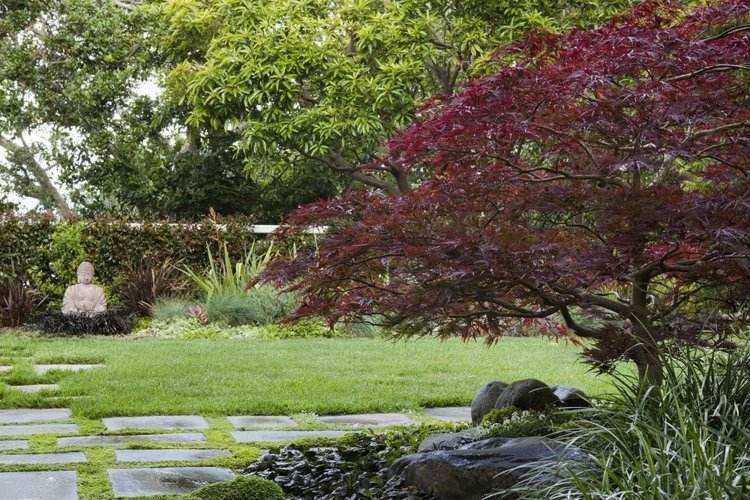 asian-garden-decoration-buddha-statue-garden-japanese-maple-grass