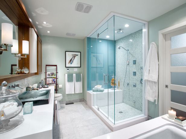 Banheiro com chuveiro com box amplo e parede de vidro marítimo