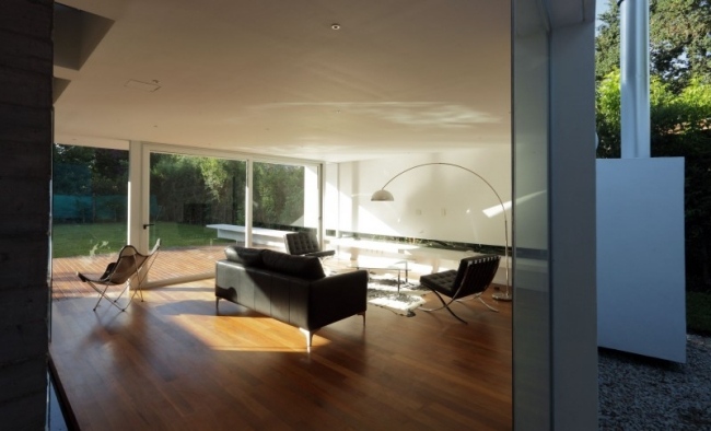Casa moderna com piso de madeira na sala de estar - grande fachada de vidro - casa de abrigo