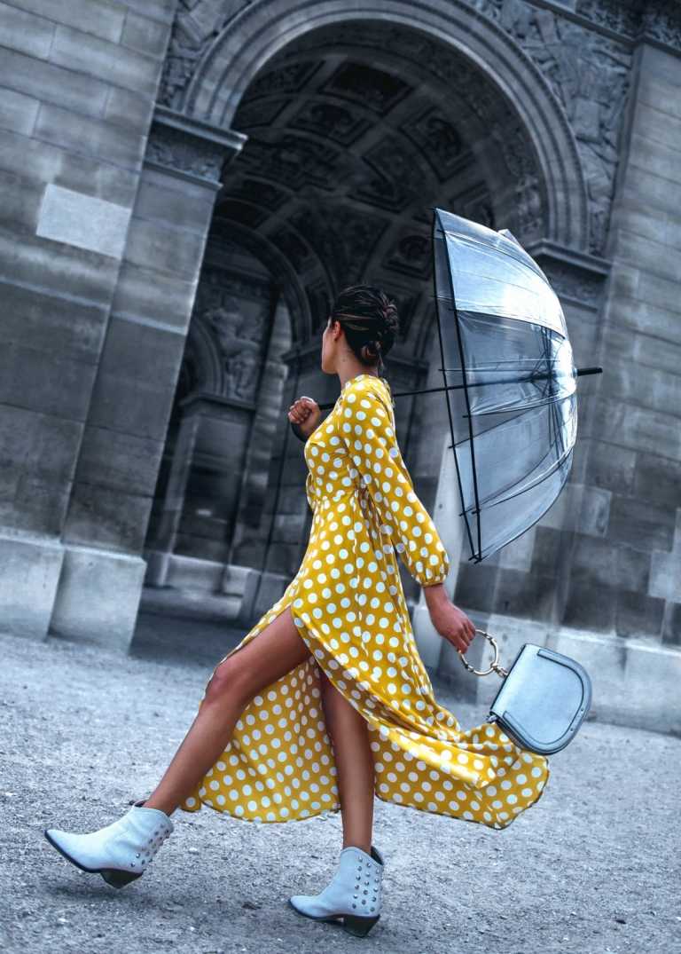 Rainwear para mulheres com um vestido de mangas compridas, botas e um guarda-chuva transparente