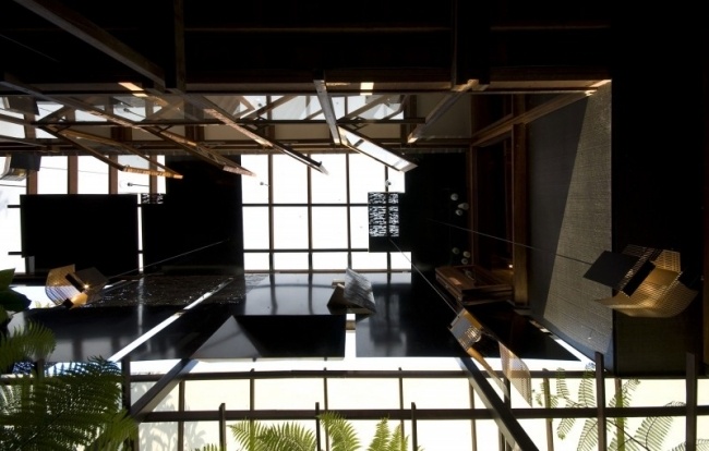 sala moderna com telhado de vidro em casa unifamiliar inundada de luz