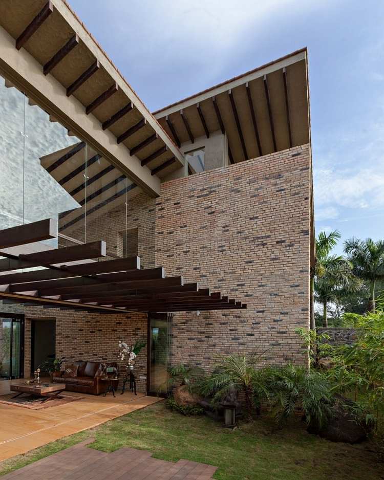 materiais-terraço telhado-madeira-casa-tijolo-parede-jardim-palma-vidro-parede-couro + sofá