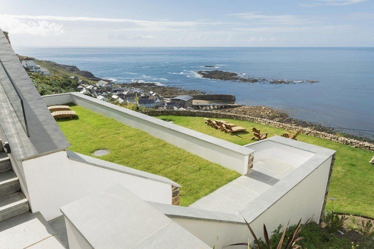 casa-encosta-terraço-gramado-espreguiçadeiras-madeira-vista para o mar