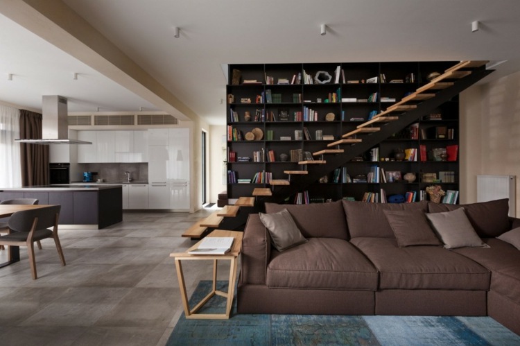 projeto da casa com prateleira acento sofá almofadas marrons escadas mesa lateral de madeira