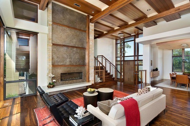 Sala de estar estilo country com lareira parede de pedra