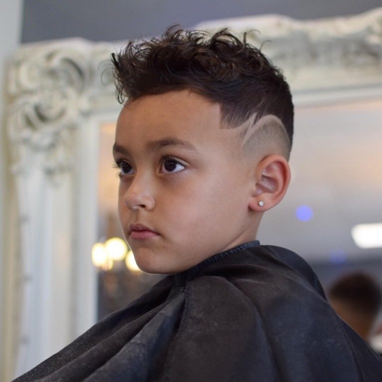 Corte de cabelo com cortes rebaixados e cachos modelando a parte superior do cabelo