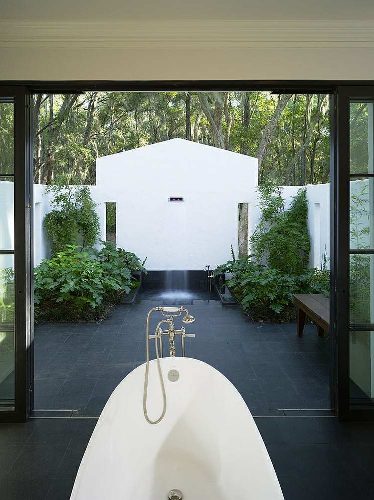 Banheiro de design moderno, banheira vitoriana e vista para o pátio interno