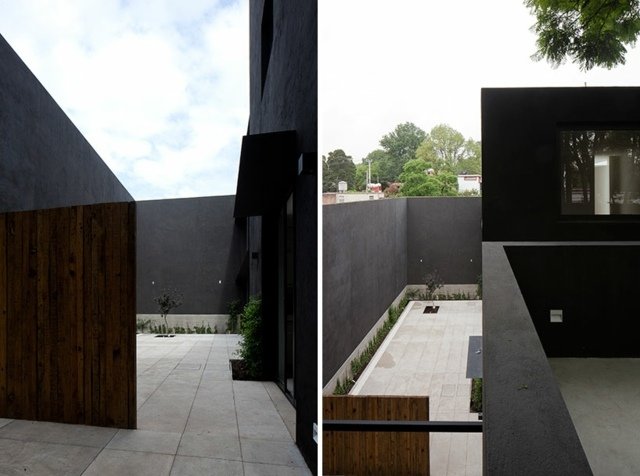 As pedras de pavimentação cobrem a porta da garagem com design de parede de concreto de alta privacidade