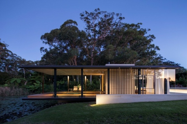 Casa de campo com fachada de vidro, madeira, concreto, lago, bela natureza