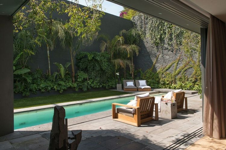 terraço poltrona de pedra piso cinza móveis de jardim piscina