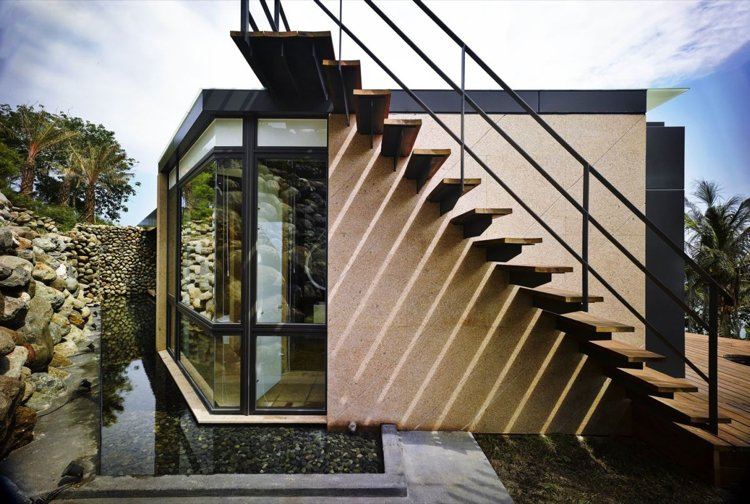 pedras naturais-pedregulhos-arquitetura moderna-escadas-telhado-terraço-casa-lagoa-água