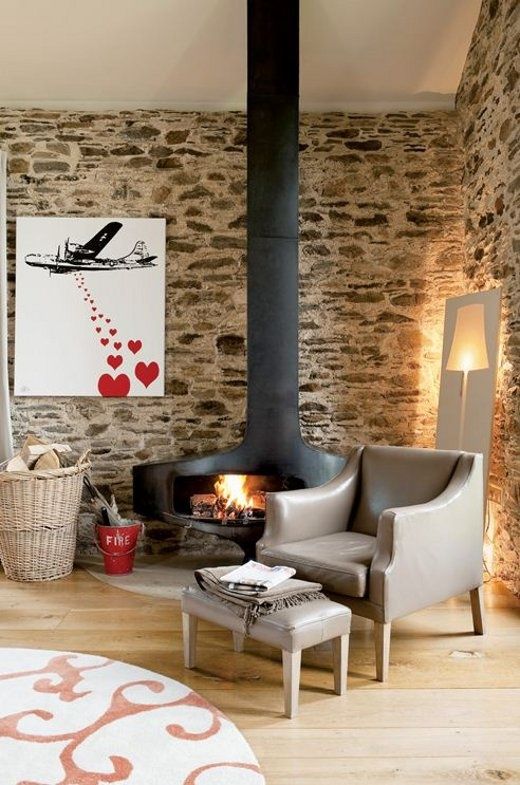 Parede de pedra natural na sala de estar, lareira e canto de leitura