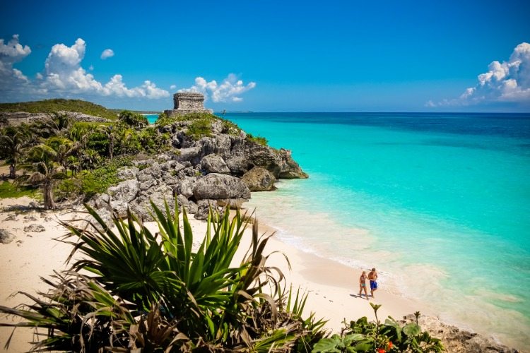 resort à beira-mar no México chamado tulum com uma praia vazia e poucos turistas
