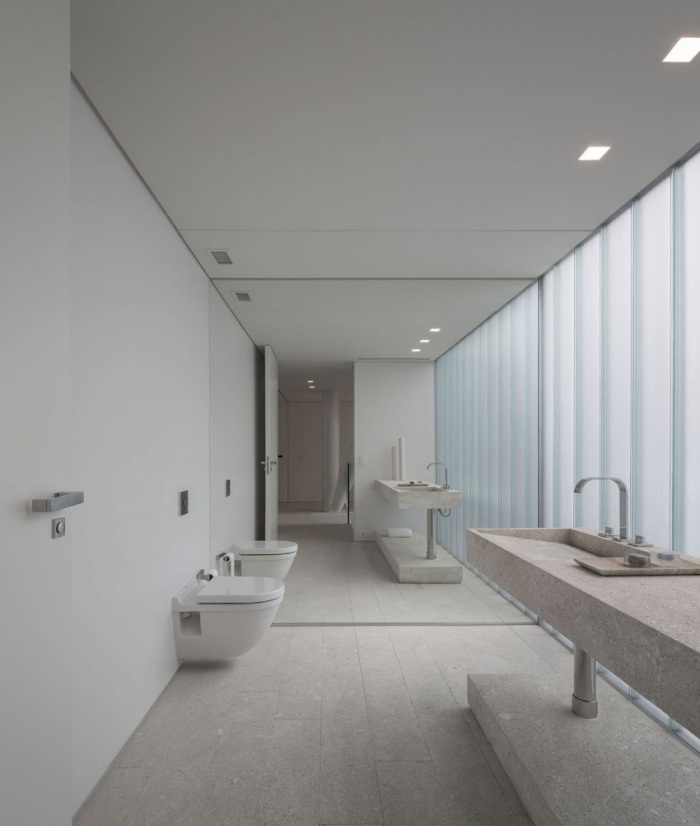 Vaso sanitário com design de plano aberto e aparência de concreto na parede