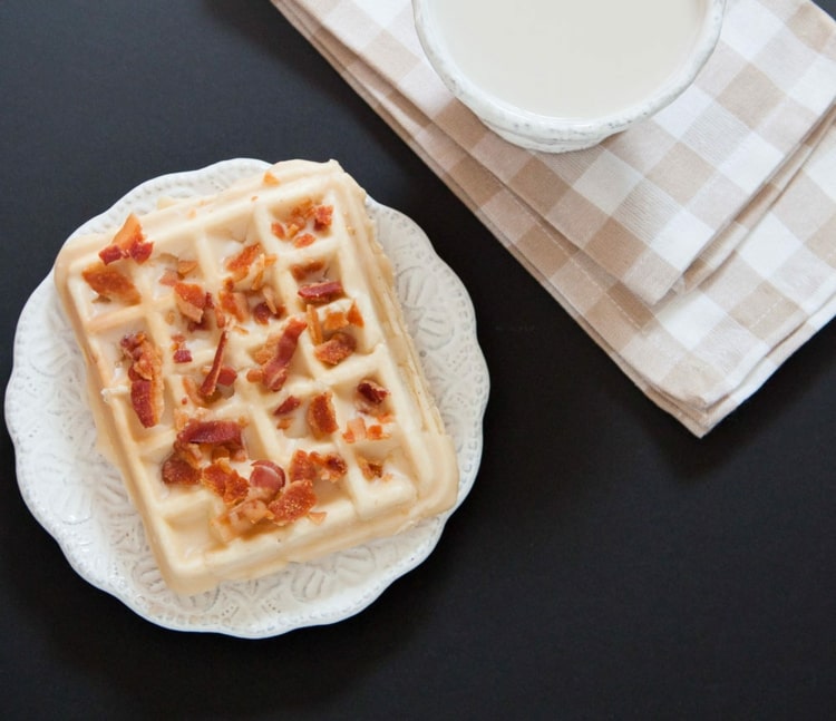 Waffles com cobertura de xarope de bordo e bacon frito para um acompanhamento perfeito