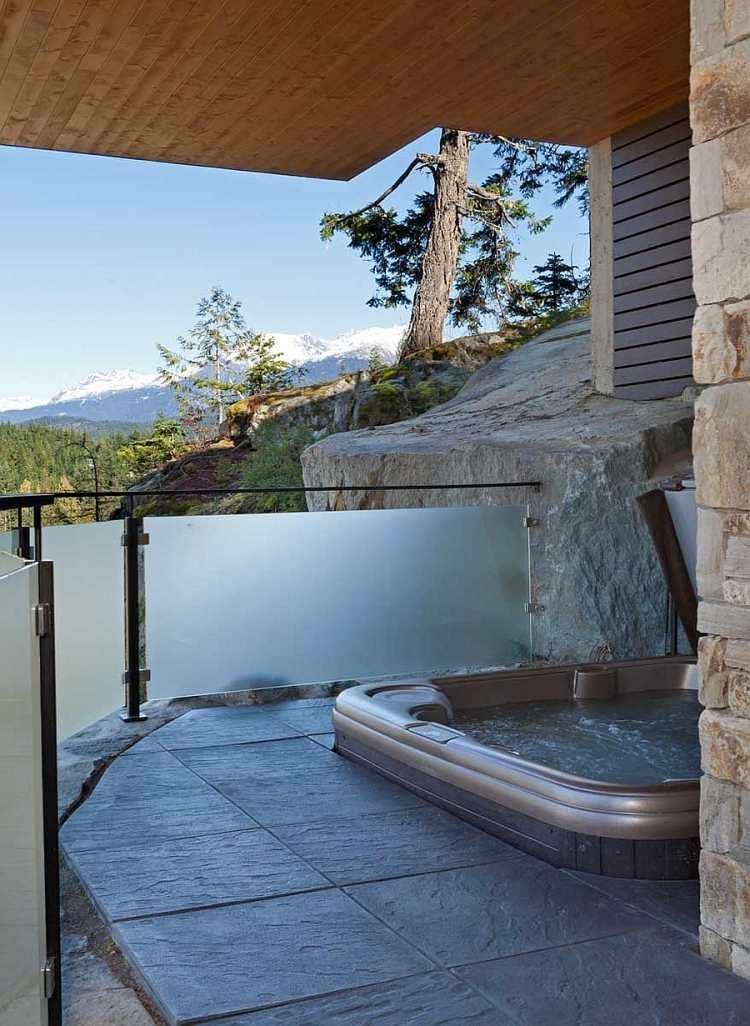whirlpool-garden-glass railing-installation-stone-floor-wall-wall-mountains-view-snow