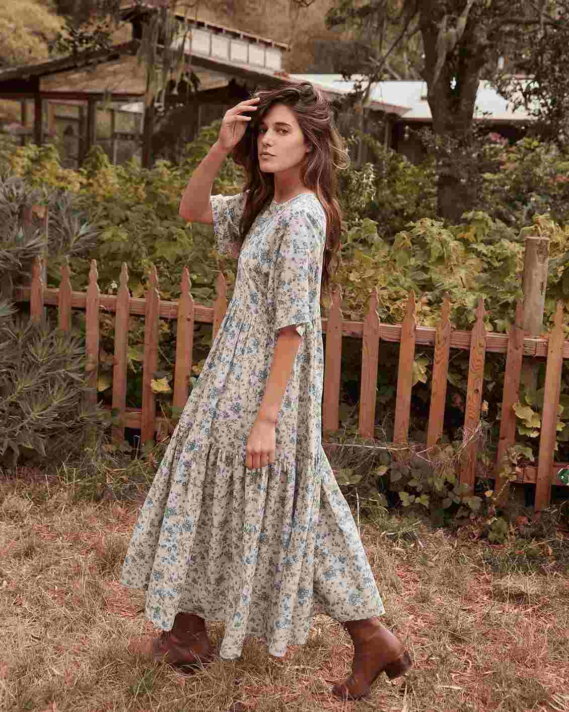 Os vestidos da pradaria combinam vestidos longos com tendência da moda. Boho look boho com estampa floral botins cowboy