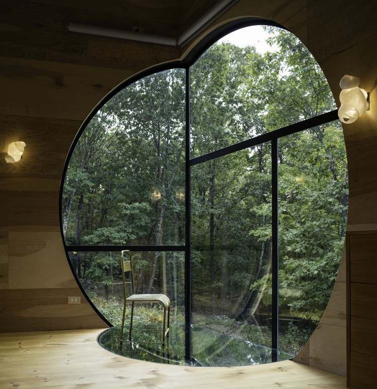 solar-house-wood-large-round-window-eye-catching-design