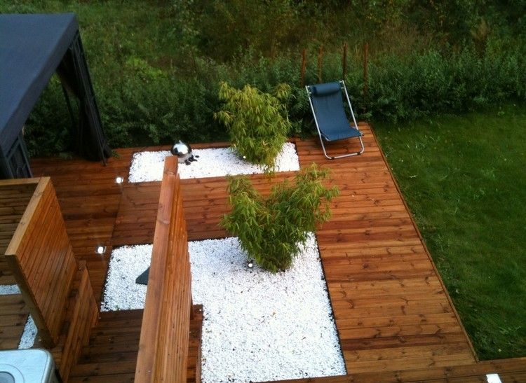 stone-bed-design-white-gravel-bamboo-plants-floor-lights-wood-terrace