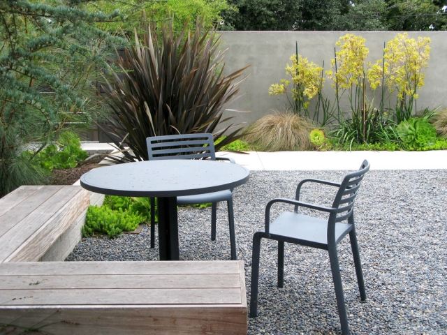 Área de estar-no-jardim-banco de madeira-metal-cadeiras-lava-cascalho cinza