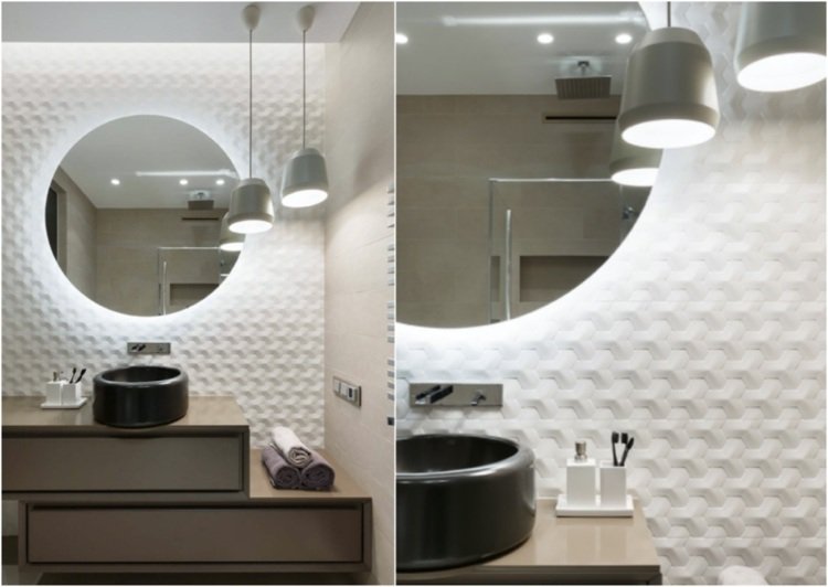 banheiro moderno com azulejos geométricos atrás de uma pia redonda de bancada
