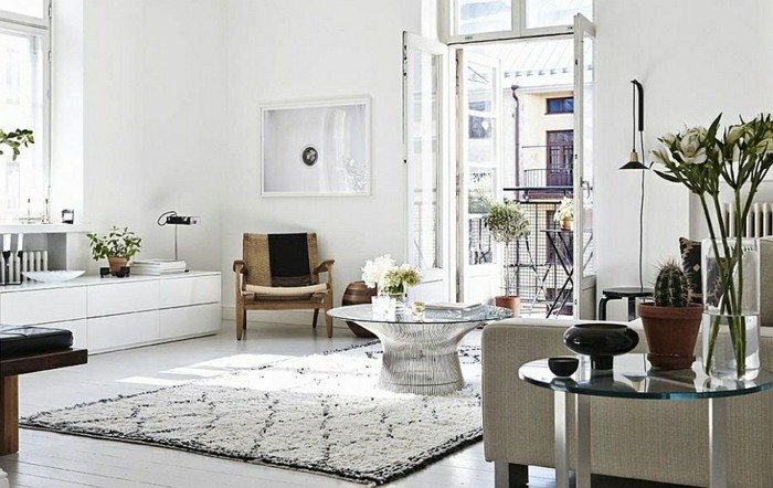 sala de estar com carpete estilo escandinavo sofá aparador preto e branco